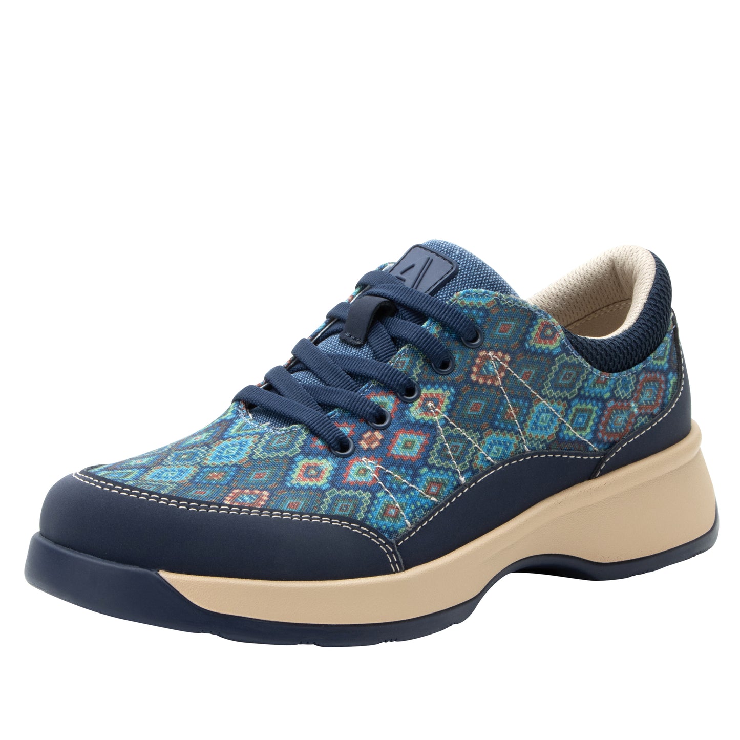 The Alegria Florah FLR-6334 in Origin Story is a stylish blue-patterned lace-up sneaker designed for comfort, featuring a water-resistant leather and canvas upper