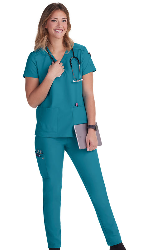 Koi Cureology Cardi C101 women's v-neck scrub top in teal blue with moisture-wicking fabric and functional pockets for healthcare professionals.