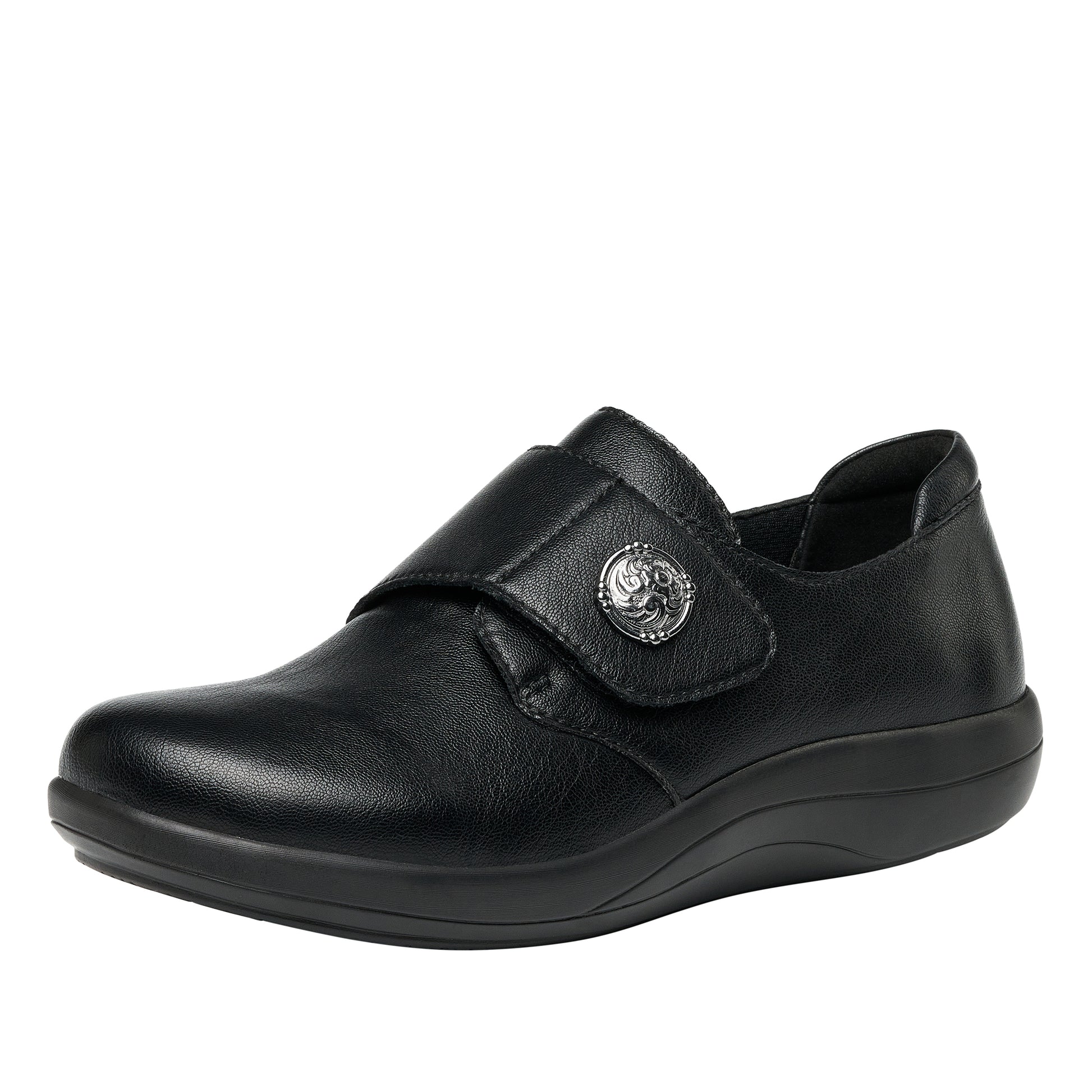 Black shoe with a strap and decorative buckle on a white background