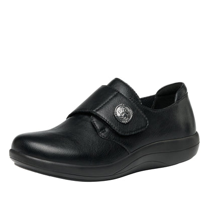 Black shoe with a strap and decorative buckle on a white background