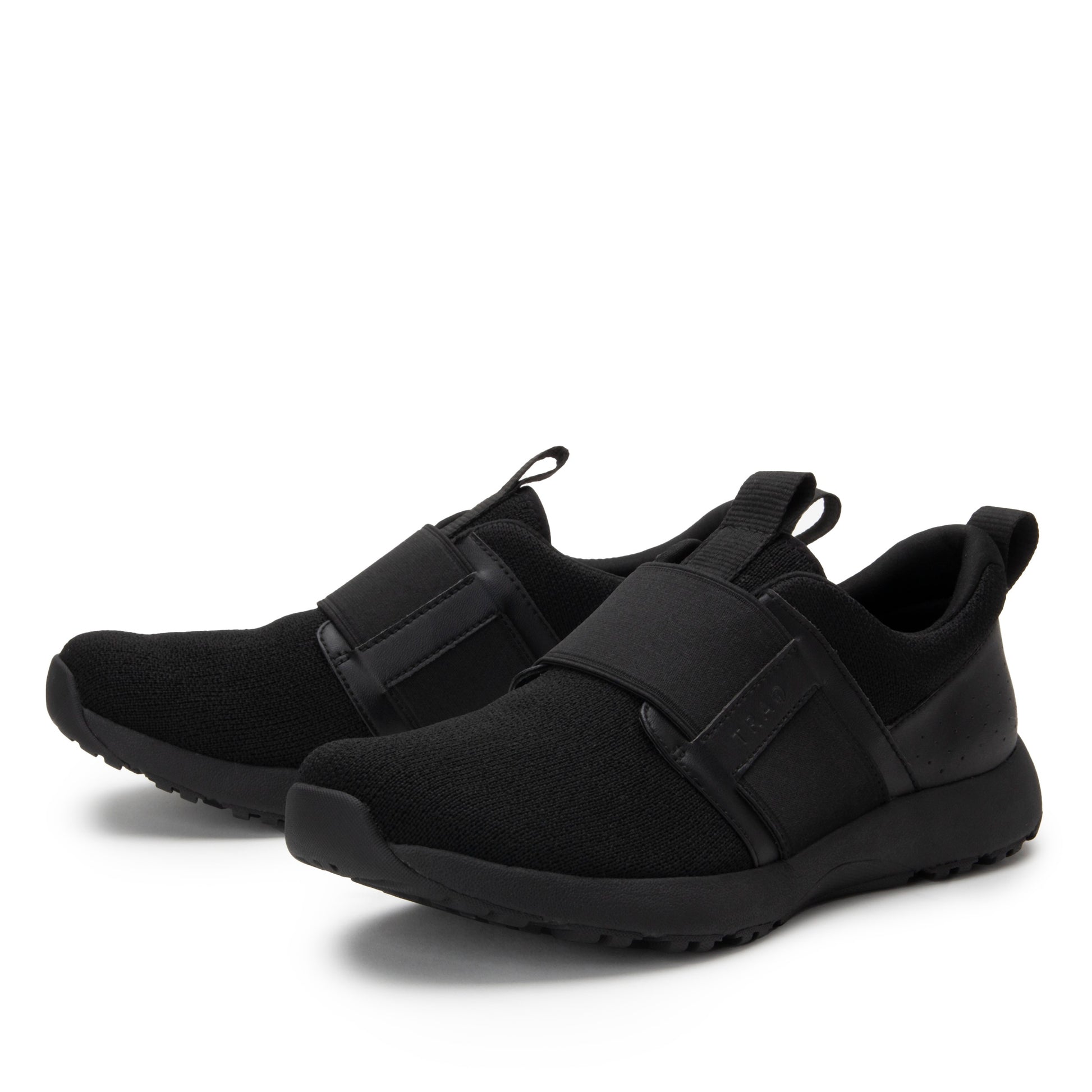Pair of black slip-on sneakers on a white background