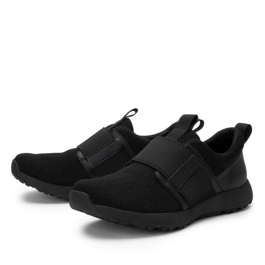 Pair of black slip-on sneakers on a white background