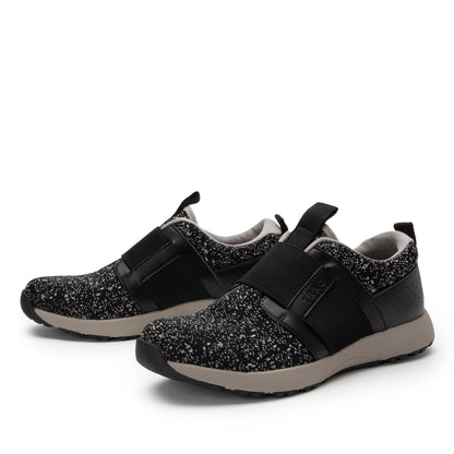 Black and gray sneakers with velcro straps on a white background