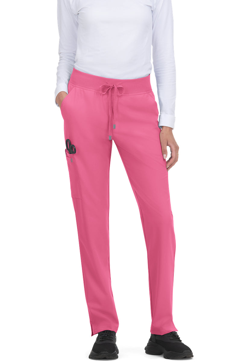 koi Cureology Atria C701 women's tapered leg scrub pants in carnation pink showing moisture-wicking stretch twill construction and multiple storage pockets.
