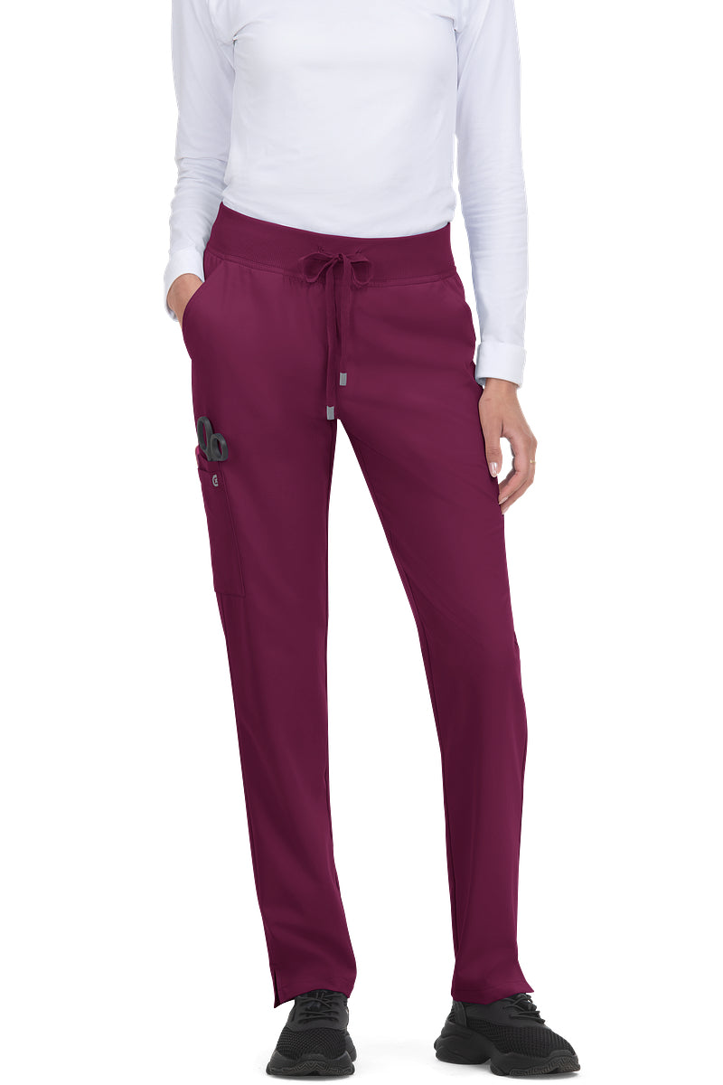 koi Cureology Atria C701 women's tapered leg scrub pants in wine burgundy showing stretch twill performance fabric and multi-pocket storage system.