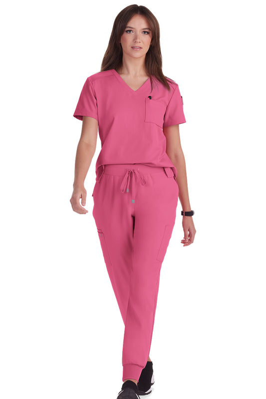 Women's Koi Cureology Aura C100 tuck in scrub top in carnation pink - moisture-wicking v-neck medical scrub with functional pockets for nurses and healthcare professionals.