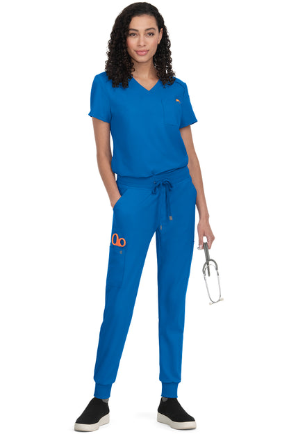 Women's Koi Cureology Aura C100 tuck in scrub top in royal blue - moisture-wicking v-neck medical scrub with functional pockets for nurses and healthcare professionals.