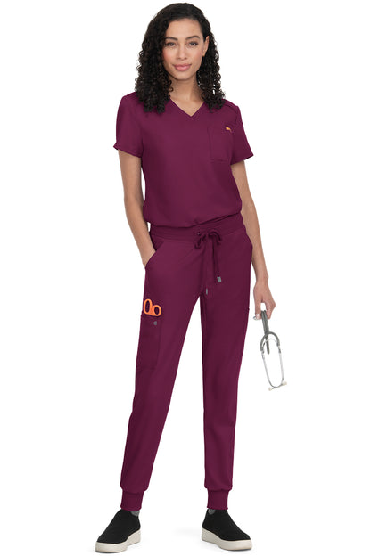 Women's Koi Cureology Aura C100 tuck in scrub top in wine red - moisture-wicking v-neck medical scrub with functional pockets for nurses and healthcare professionals.