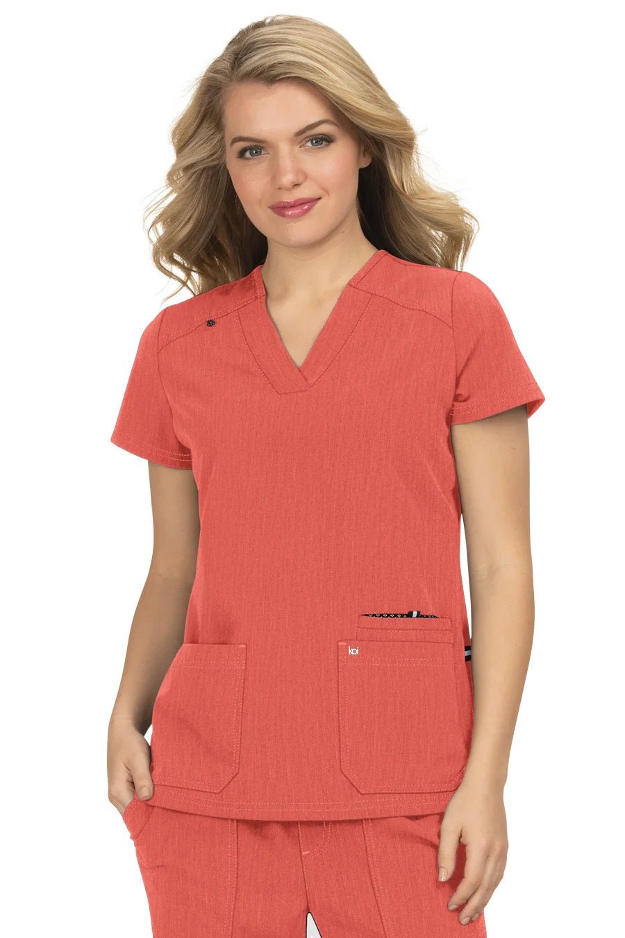 Koi Next Gen Hustle and Heart scrub top 1019 in Heather Coral - machine washable nursing scrub with modern classic fit and functional design.
