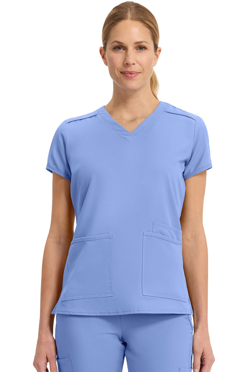 Med Couture Insight 2411 women's scrub top in ceil blue featuring classic v-neck, 3 functional pockets, and box pleat design for healthcare professionals
