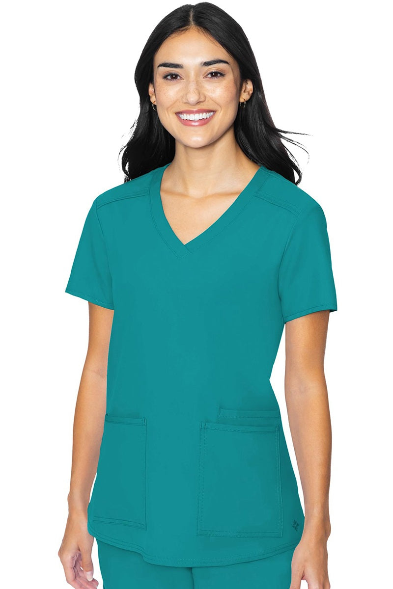 Med Couture Insight 2411 women's scrub top in teal blue featuring classic v-neck, 3 functional pockets, and box pleat design for healthcare professionals
