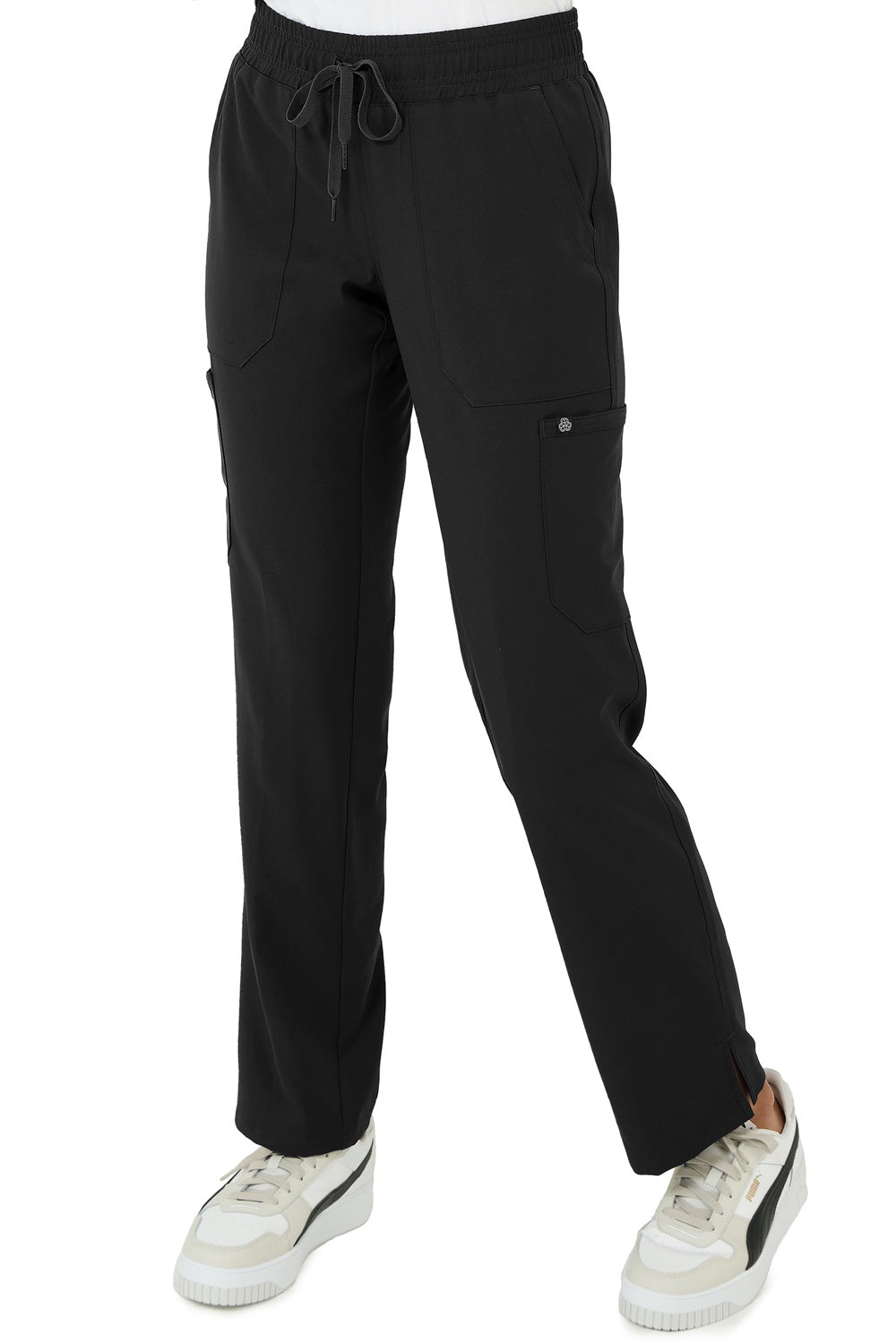 Healthcare professional wearing Zavate Studio Energy straight leg scrub pants in black with elastic waistband and multiple pockets.