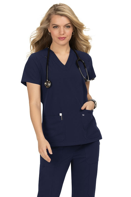 Koi Next Gen Hustle and Heart scrub top 1019 in Navy Blue - machine washable medical scrub top with wide V-neck for nurses and medical assistants.
